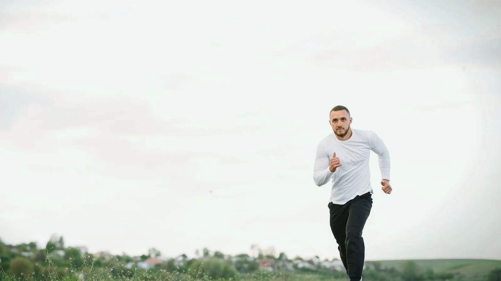 A man running outdoors across an open field