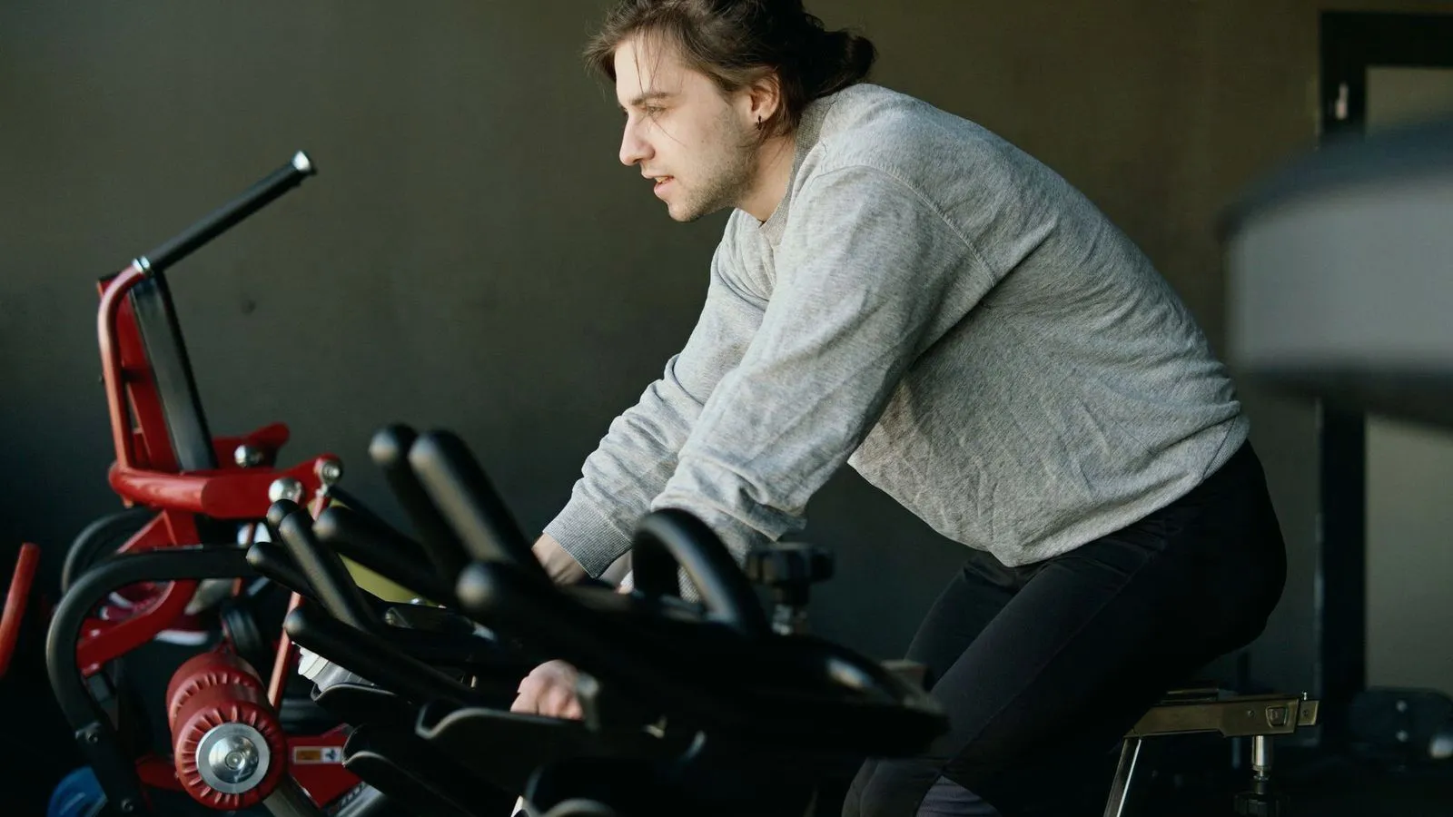 A man riding a stationary exercise bike in a gym