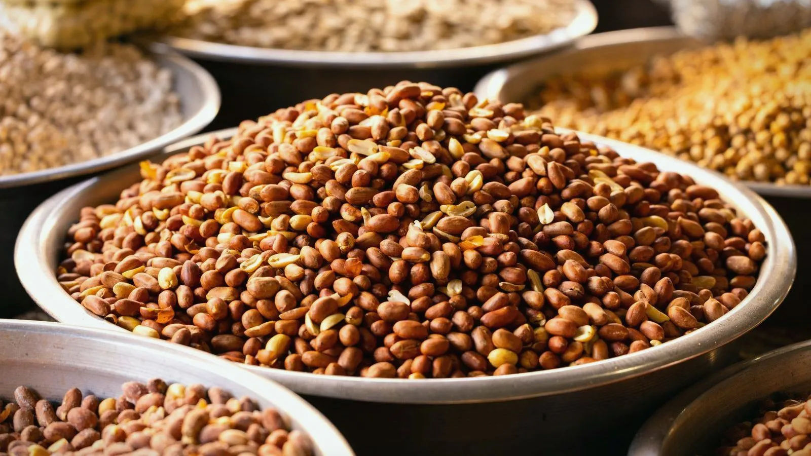 Large bowls of dried beans and pulses on a market stall