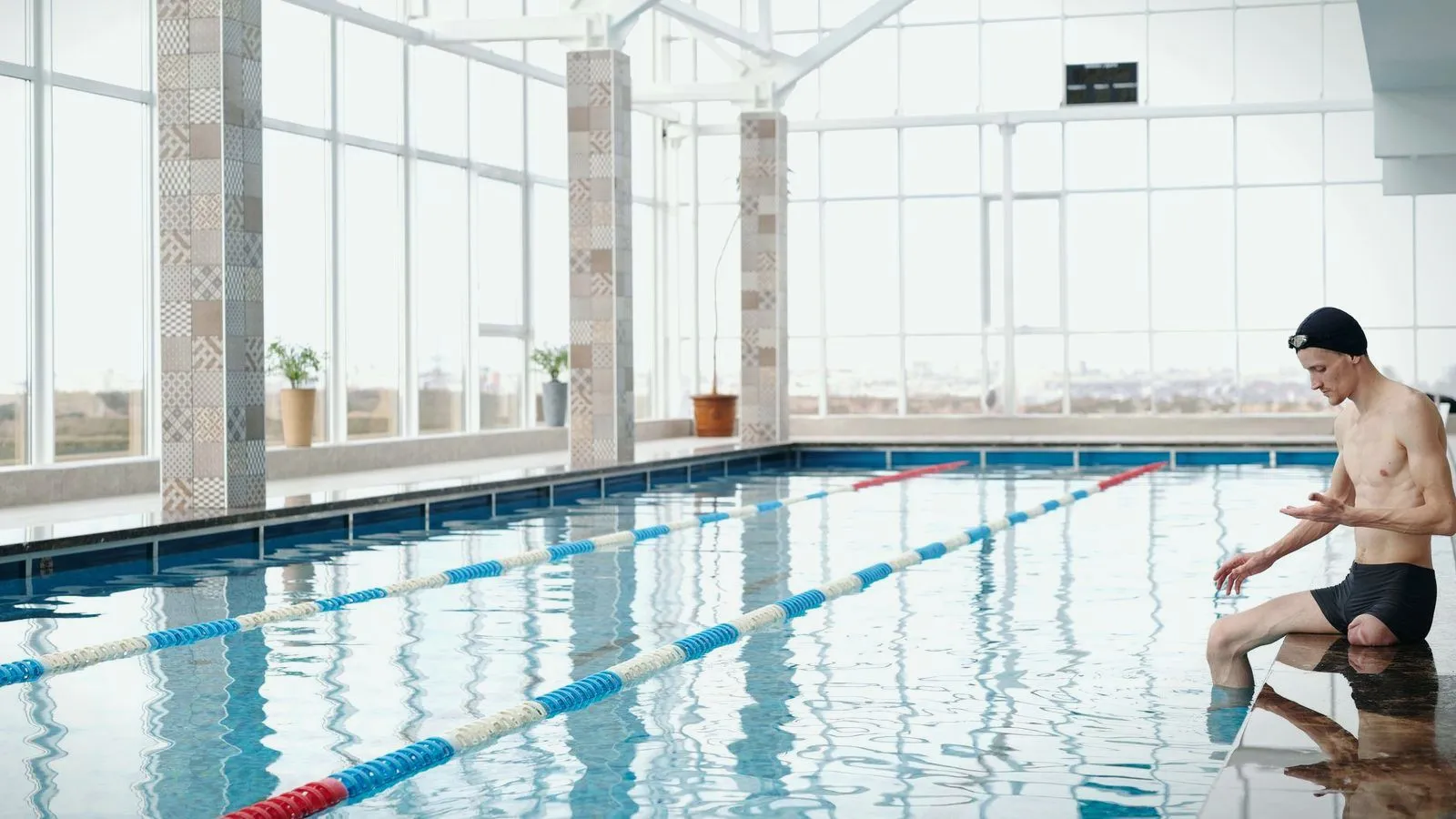Lane ropes across a bright indoor swimming pool