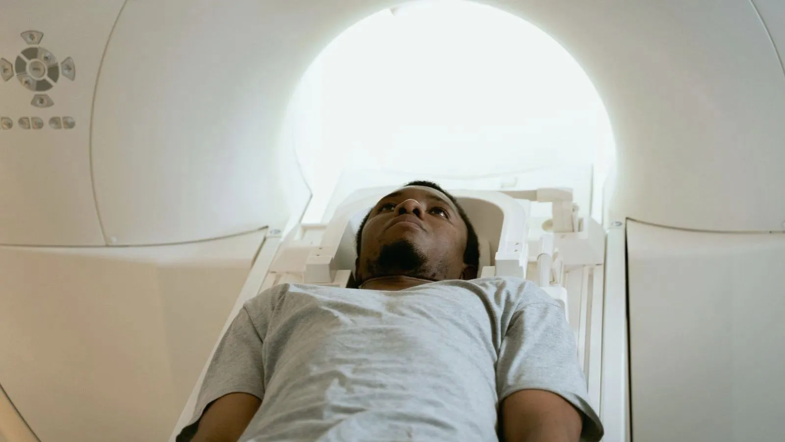 A patient lying on the table of a CT scanner