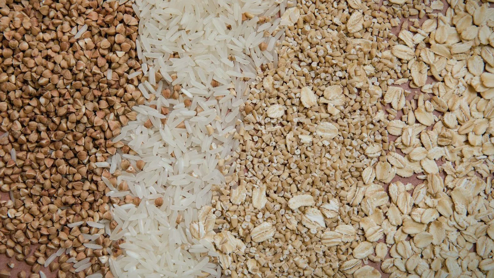 Stripes of buckwheat, rice and rolled oats filling the frame